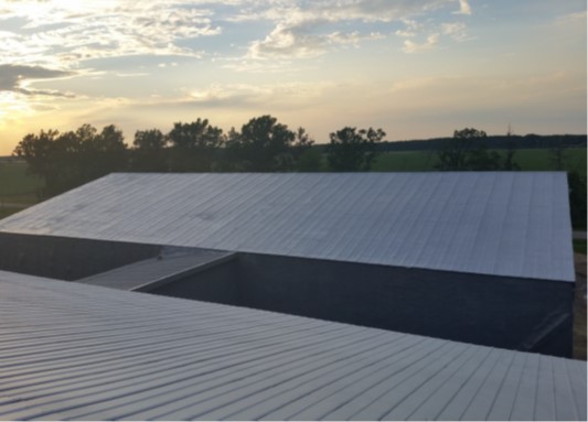 Agricultural storage building being insulated with spray foam